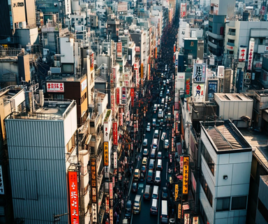 Aerial view of densely packed commercial buildings in an urban Japanese entertainment district showing narrow streets and tightly spaced multi-story structures typical of Osaka's Shinsaibashi area